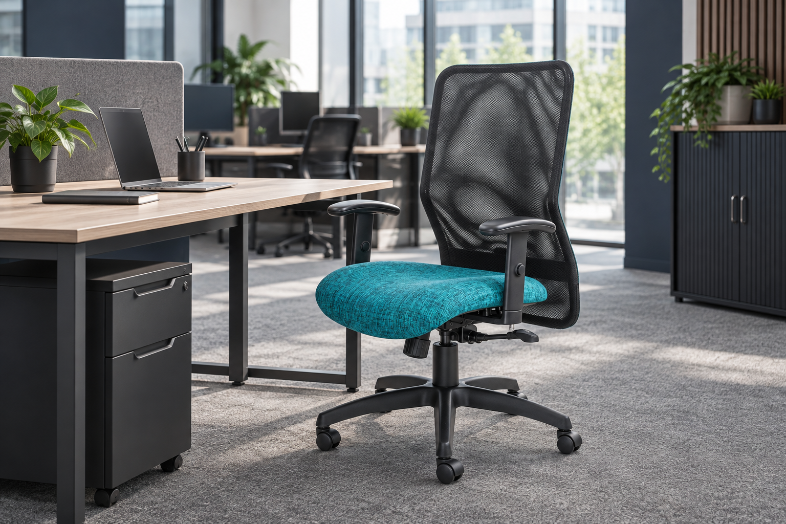 Black mesh office chair with a teal seat in a contemporary workspace
