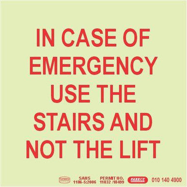 Photoluminescent 190 mm SABS Approved Sign by 67, Displaying "in Case of Emergency Use the Stairs and Not the Lift" in Red Text on a Pale Background, Providing Essential Wayfinding Information for Emergency Procedures.