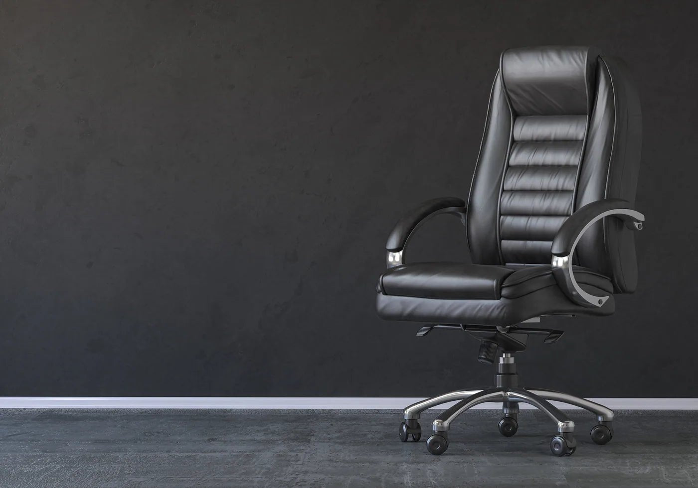 Black high-back executive office chair on a charcoal studio background